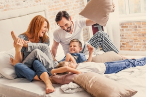 Dad, mom, and two sons laughing 